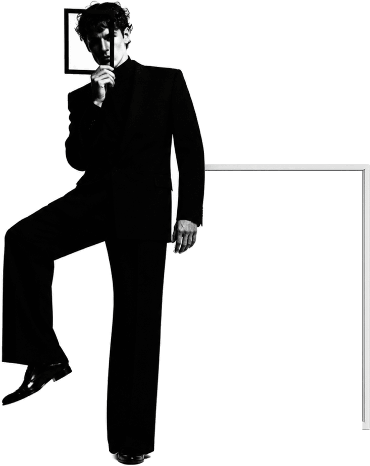 A Fellwind creative in a tailored black suit holding a framed square to their face